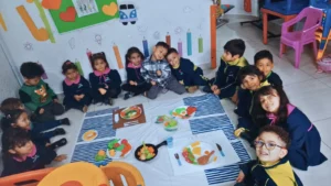 Niños sentados en círculo participando en actividades lúdicas.